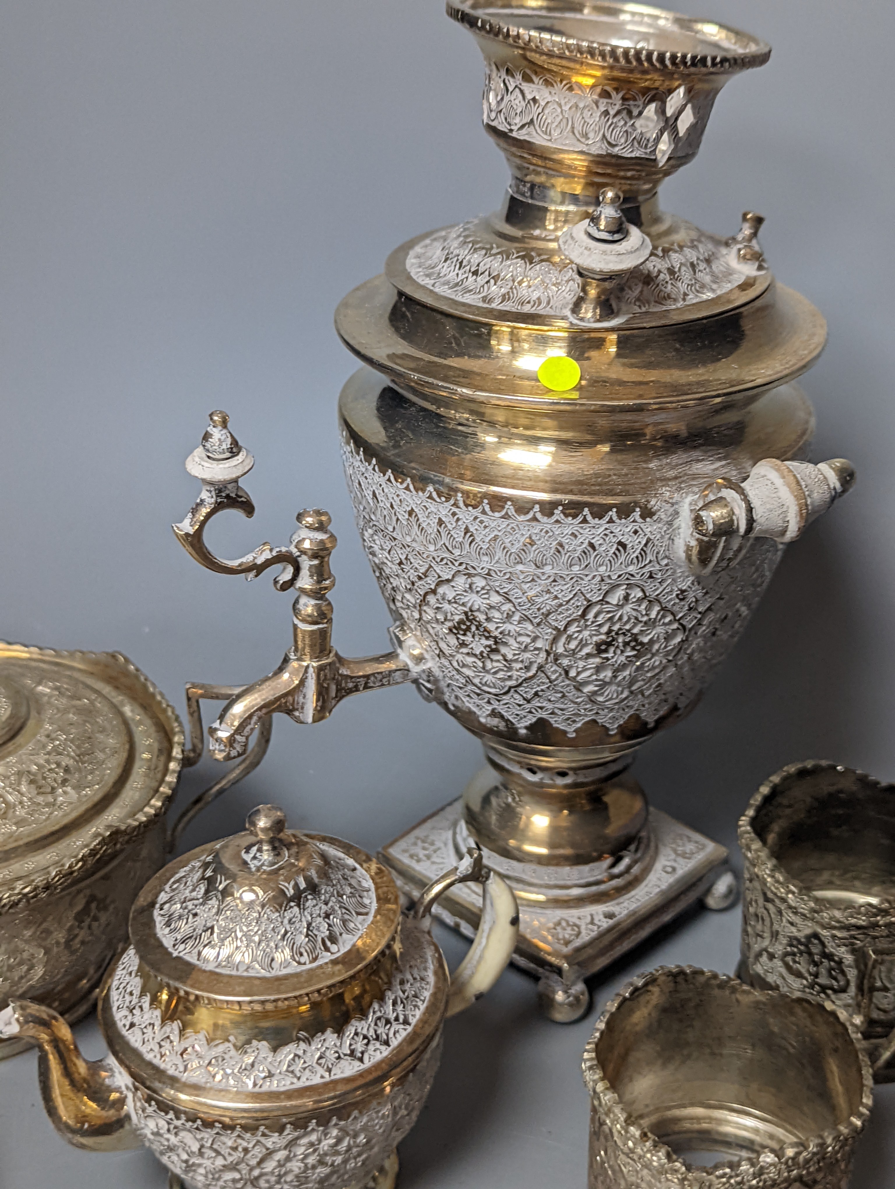 A set of six Persian embossed 84 standard white metal coffee cup holders and matching sugar bowl and cover by Vartan and four other Persian white metal items.
